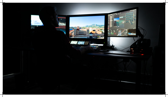 Dimly lit edit bay with monitors showing a timeline