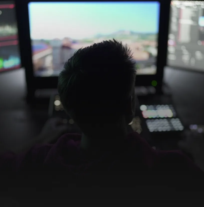 Post supervisor reviewing a project on a monitor