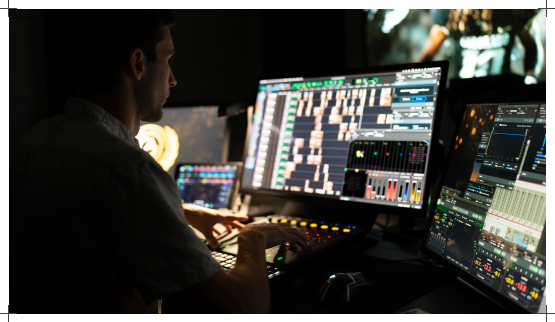 Mix engineer working at a Pro Tools console in the mix bay
